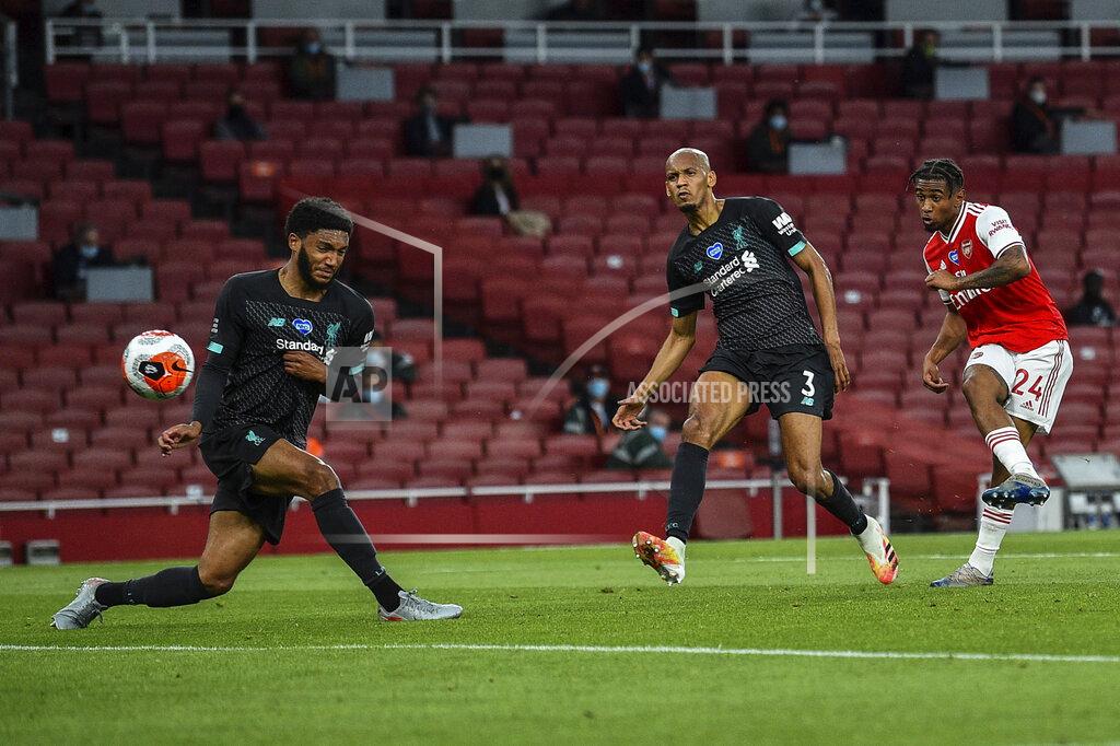 Glyn Kirk Arsenal's Reiss Nelson, right, scores his team second goal during the English Premier League soccer match between Arsenal and Liverpool at the Emirates Stadium in London, England, Wednesday, July 15, 2020. (Glyn Kirk/Pool via AP)