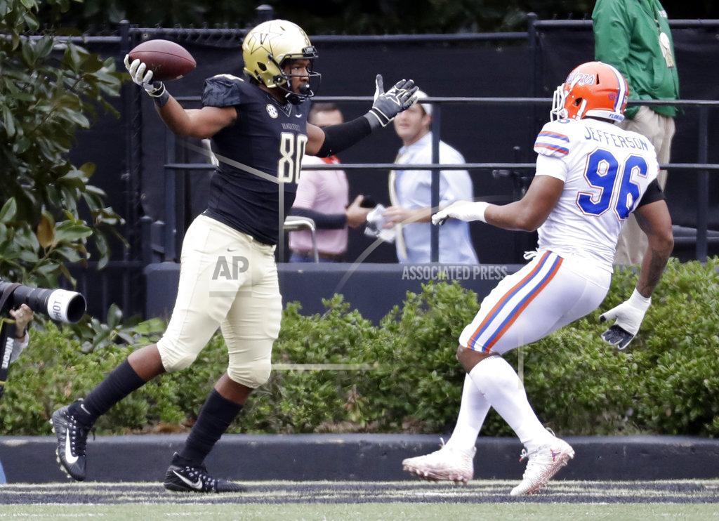 Mark Humphrey Vanderbilt tight end Jared Pinkney (80) celebrates after scoring a touchdown ahead of Florida defensive lineman Cece Jefferson (96) in the first half of an NCAA college football game Saturday, Oct. 13, 2018, in Nashville, Tenn. (AP Photo/Mark Humphrey)
