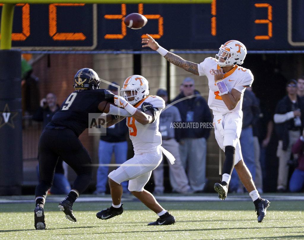 Mark Humphrey Tennessee quarterback Jarrett Guarantano (2) passes as running back Tim Jordan, center, blocks Vanderbilt linebacker Caleb Peart (9) in the first half of an NCAA college football game Saturday, Nov. 24, 2018, in Nashville, Tenn. (AP Photo/Mark Humphrey)