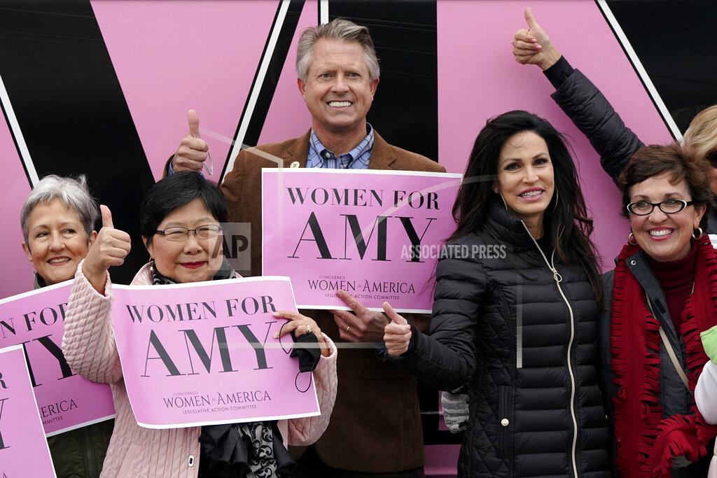 Charlie Riedel U.S. Rep. Roger Marshall, R-Kan., poses for a photo with a group of women attending a Concerned Women for America event outside a gun store in Kansas City, Kan. Wednesday, Oct. 21, 2020. Marshall is facing stiff competition from state Sen. Barbara Bollier in the race to fill an open Senate seat in Kansas. (AP Photo/Charlie Riedel)