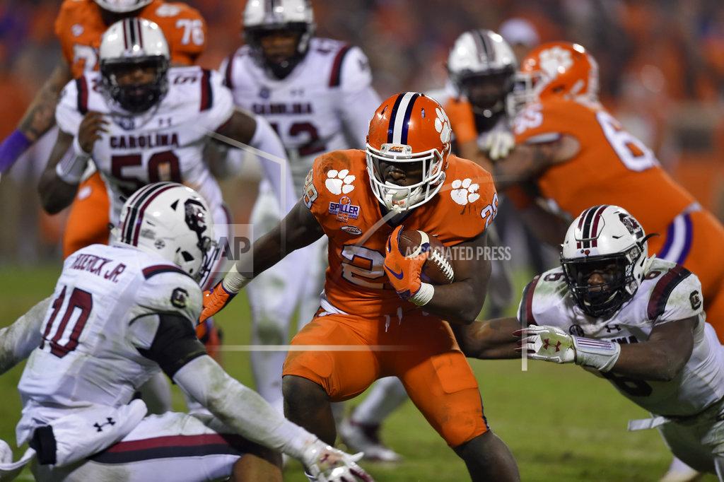 Richard Shiro Clemson's Tavien Feaster (28) rushes for a touchdown while defended by South Carolina's R.J. , left, and D.J. Wonnum during the second half of an NCAA college football game Saturday, Nov. 24, 2018, in Clemson, S.C. Clemson won 56-35. (AP Photo/Richard Shiro)