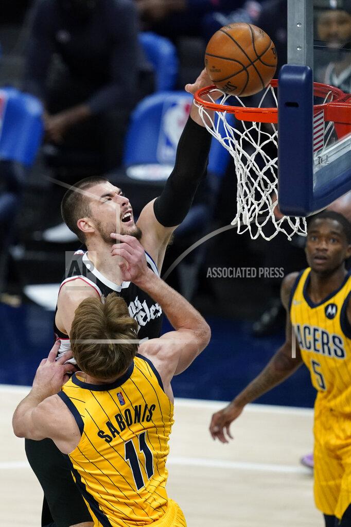 Darron Cummings Los Angeles Clippers' Ivica Zubac (40) dunks over Indiana Pacers' Domantas Sabonis (11) during the first half of an NBA basketball game, Tuesday, April 13, 2021, in Indianapolis. (AP Photo/Darron Cummings)