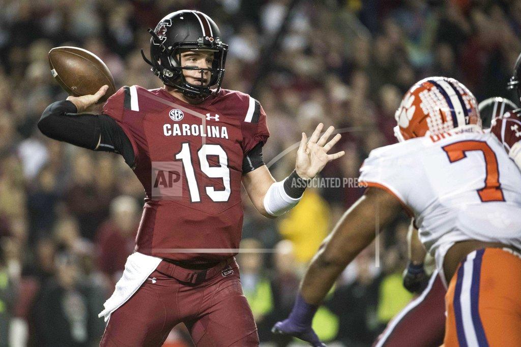 Sean Rayford South Carolina quarterback Jake Bentley (19) attempts a pass against Clemson defensive end Austin Bryant (7) during the first half of an NCAA college football game Saturday, Nov. 25, 2017, in Columbia, S.C. (AP Photo/Sean Rayford)