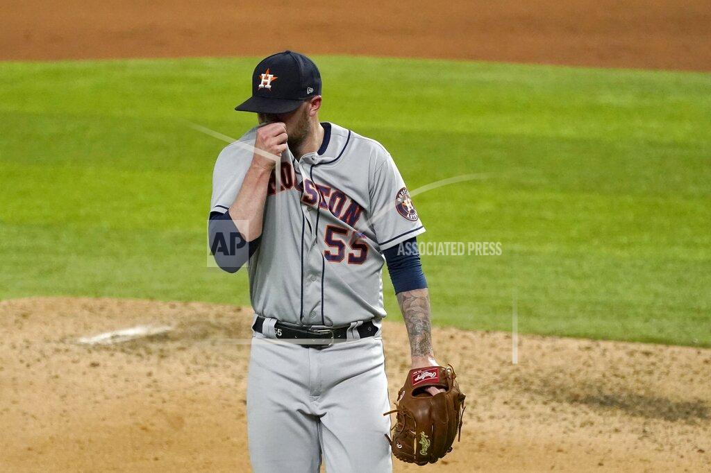 Tony Gutierrez Houston Astros' Ryan Pressly (55) wipes his face as he walks to the dugout in the ninth inning of a baseball game against the Texas Rangers in Arlington, Texas, Friday, Sept. 25, 2020. Pressly gave up a tying solo home run to Rangers' Ronald Guzman in the inning. (AP Photo/Tony Gutierrez)