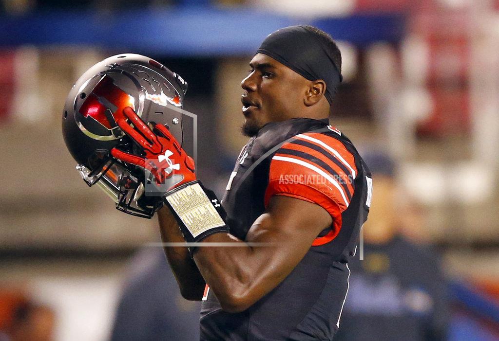 Rick Bowmer FILE - In this Nov. 3, 2017, file photo, Utah quarterback Tyler Huntley looks on during practice before the start of their NCAA college football game against UCLA, in Salt Lake City. Making more plays with his arm rather than his legs has become a primary goal for Huntley this season. (AP Photo/Rick Bowmer, File)