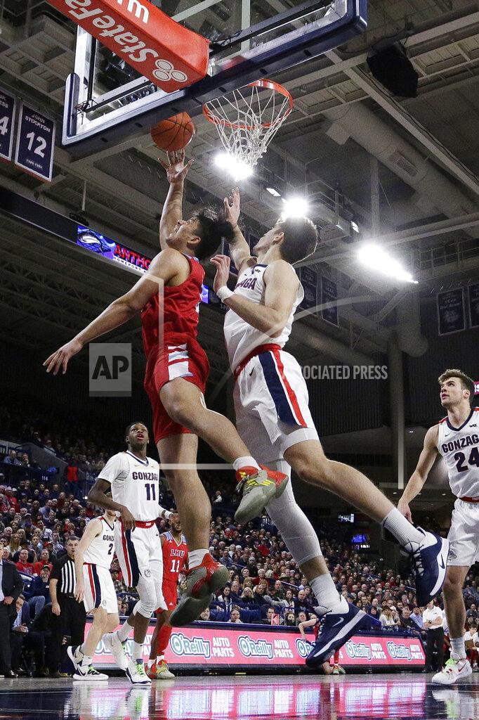 Young Kwak Loyola Marymount forward Keli Leaupepe, left, shoots in front of Gonzaga forward Filip Petrusev during the first half of an NCAA college basketball game in Spokane, Wash., Thursday, Feb. 6, 2020. (AP Photo/Young Kwak)