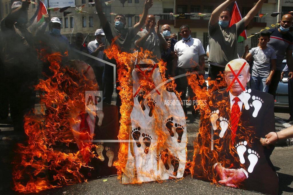 Majdi Mohammed FILE - In this Aug. 14, 2020 file photo, Palestinians burn pictures of U.S. President Donald Trump, Abu Dhabi Crown Prince Mohammed bin Zayed al-Nahyan and and Israeli Prime Minister Benjamin Netanyahu during a protest against the United Arab Emirates' deal with Israel, in the West Bank city of Nablus. Palestinian President Mahmoud Abbas has announced that the first presidential and parliamentary elections since 2006 will be held later in 2021. The voting is seen as a key step in mending a rift between Abbas’ Fatah party that rules the West Bank and the Islamic militant group Hamas that controls the Gaza Strip. ( (AP Photo/Majdi Mohammed, File)
