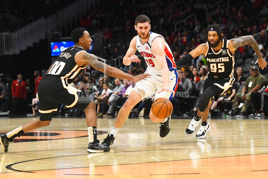 John Amis Detroit Pistons guard Sviatoslav Mykhailiuk, center, tries to split the defense of Atlanta Hawks guards Jeff Teague (00) and DeAndre' Bembry (95) during the second half of an NBA basketball game Saturday, Jan. 18, 2020, in Atlanta. (AP Photo/John Amis)