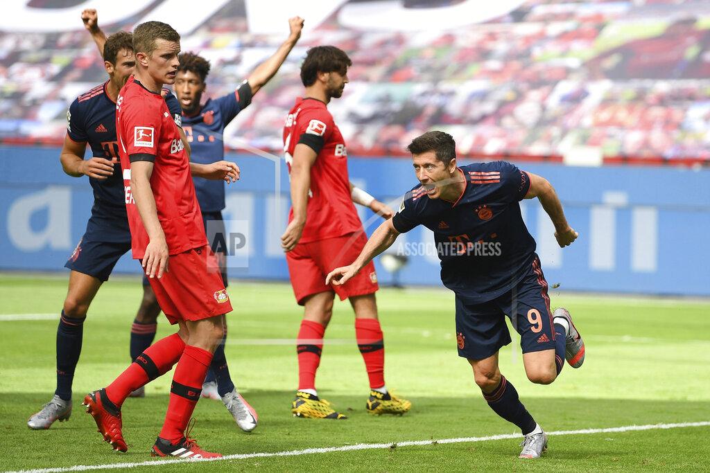 Matthias Hangst Robert Lewandowski of Munich celebrates his team's fourth goal during the German Bundesliga soccer match between Bayer Leverkusen and Bayern Munich in Leverkusen, Germany, Saturday, June 6, 2020. (Matthias Hangst, Pool via AP)
