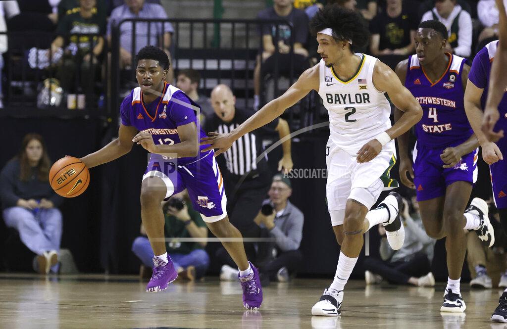 Rod Aydelotte Northwestern State guard Carvell Teasett, left, heads upcourt on a fast break past Baylor guard Kendall Brown, right, during the first half of an NCAA college basketball game Tuesday, Dec. 28, 2021, in Waco, Texas. (AP Photo/Rod Aydelotte)