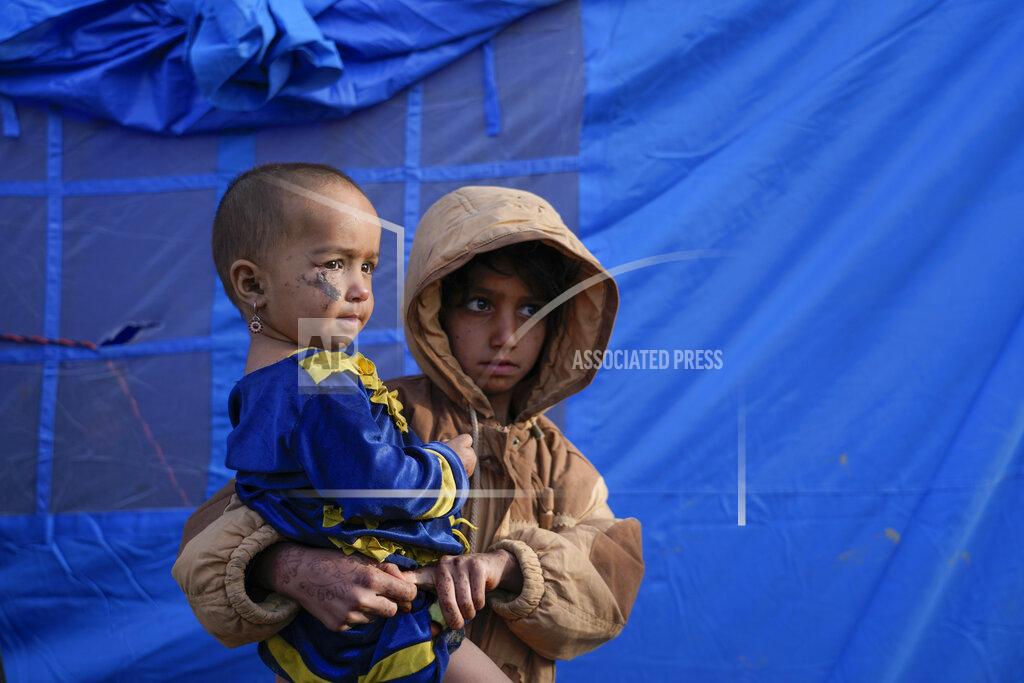 Ebrahim Noroozi Afghan children stand in front of a tent after an earthquake in Gayan village, in Paktika province, Afghanistan, Thursday, June 23, 2022. A powerful earthquake struck a rugged, mountainous region of eastern Afghanistan early Wednesday, flattening stone and mud-brick homes in the country's deadliest quake in two decades, the state-run news agency reported. (AP Photo/Ebrahim Nooroozi)