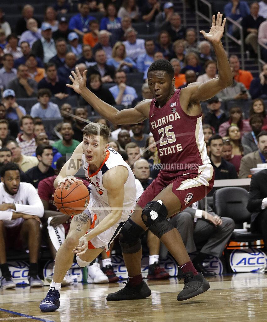 Chuck Burton Virginia's Kyle Guy, left, drives past Florida State's Mfiondu Kabengele (25) during the first half of an NCAA college basketball game in the Atlantic Coast Conference tournament in Charlotte, N.C., Friday, March 15, 2019. (AP Photo/Chuck Burton)
