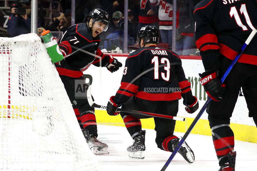 Karl B Deblaker Carolina Hurricanes' Jesper Fast (71) congratulates Max Domi (13) on his goal against the Boston Bruins during the second period of Game 7 of an NHL hockey Stanley Cup first-round playoff series in Raleigh, N.C., Saturday, May 14, 2022. (AP Photo/Karl B DeBlaker)