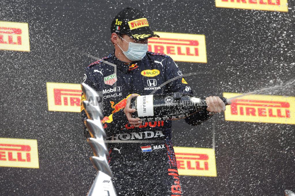 Luca Bruno Red Bull driver Max Verstappen of the Netherlands celebrates his victory on the podium of the Emilia Romagna Formula One Grand Prix, at the Imola racetrack, Italy, Sunday, April 18, 2021. (AP Photo/Luca Bruno)