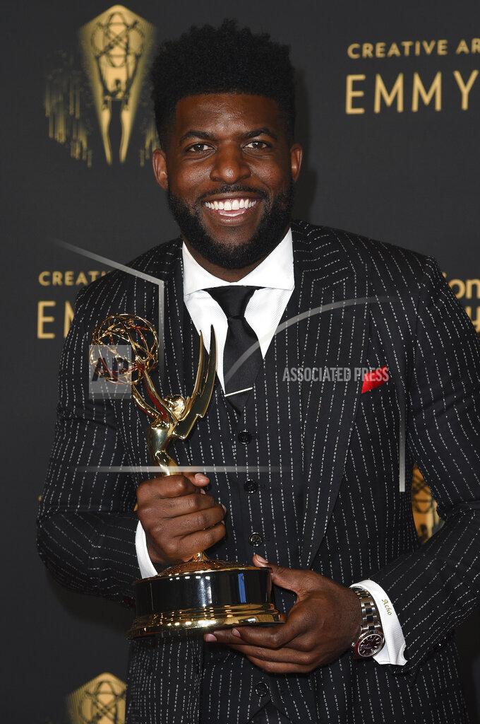 Richard Shotwell Emmanuel Acho poses with the award for short form nonfiction or reality series for "Uncomfortable Conversations with a Black Man," on night two of the Creative Arts Emmy Awards on Sunday, Sept. 12, 2021, in Los Angeles. Acho wore a suit bearing the names of Black Americans killed at the hands of police. (Photo by Richard Shotwell/Invision/AP)