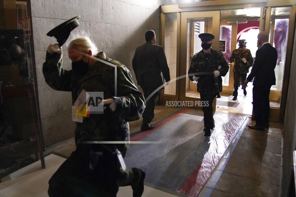 Andrew Harnik Members of the military band evacuate from the West Front of the U.S. Capitol during a rehearsal the 59th Presidential Inauguration at the U.S. Capitol in Washington, Monday, Jan. 18, 2021. (AP Photo/Andrew Harnik)