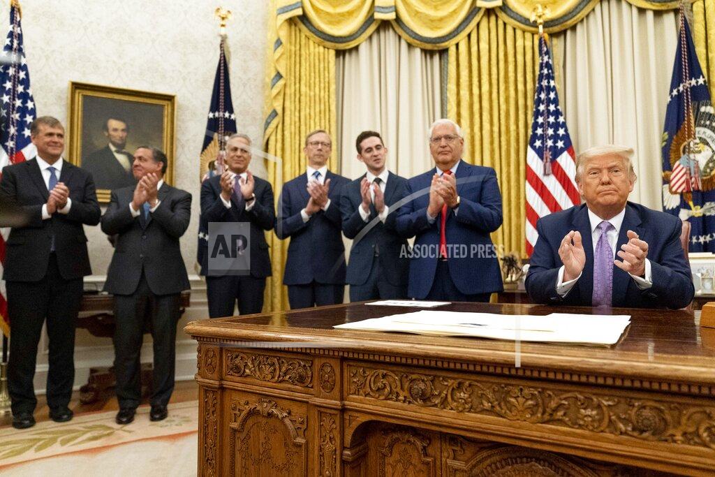 Andrew Harnik President Donald Trump, accompanied by U.S. Ambassador to Israel David Friedman, second from right, and others applaud in the Oval Office at the White House, Wednesday, Aug. 12, 2020, in Washington. Trump said on Thursday that the United Arab Emirates and Israel have agreed to establish full diplomatic ties as part of a deal to halt the annexation of occupied land sought by the Palestinians for their future state. (AP Photo/Andrew Harnik)