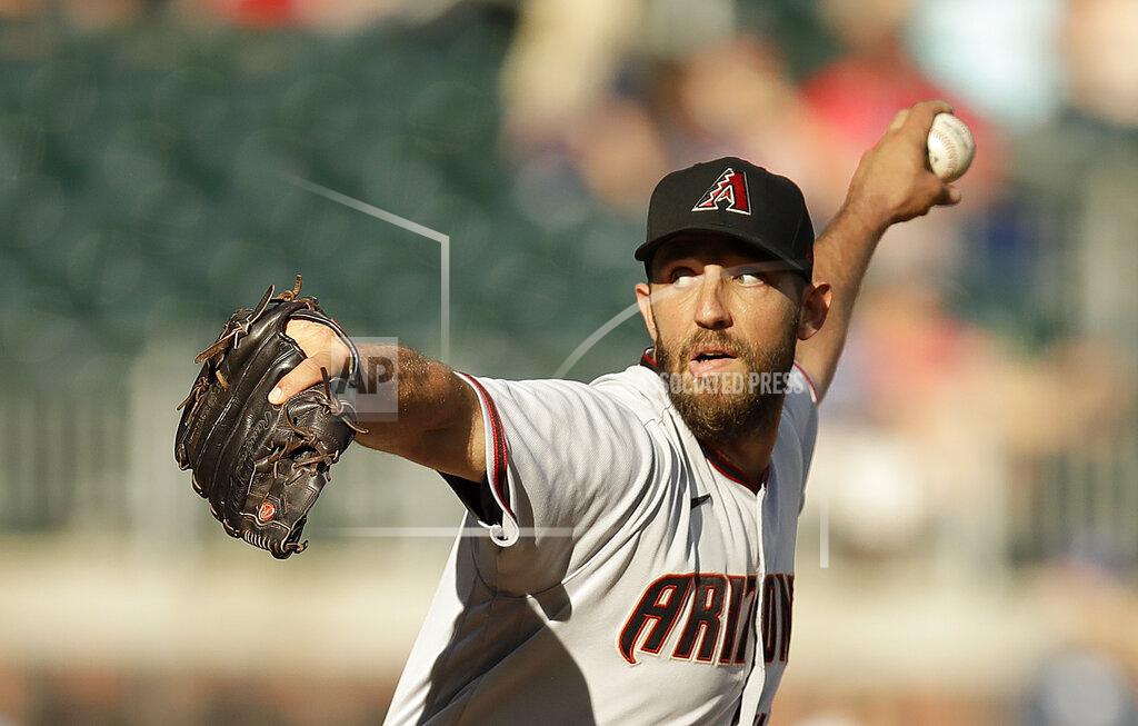 Ben Margot Arizona Diamondbacks pitcher Madison Bumgarner works against the Atlanta Braves in the seventh inning of the second baseball game of a doubleheader, Sunday, April 25, 2021, in Atlanta. (AP Photo/Ben Margot)