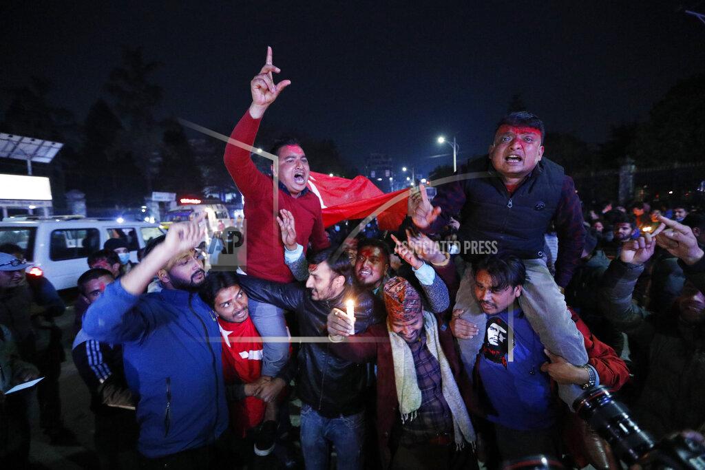 Niranjan Shrestha Nepalese supporters of the splinter group in the governing Nepal Communist Party celebrate the Supreme Court order in Kathmandu, Nepal, Tuesday, Feb. 23, 2021. Nepal's Supreme Court on Tuesday ordered the reinstatement of Parliament after it was dissolved by the prime minister, in a ruling likely to thrust the Himalayan nation into a political crisis. (AP Photo/Niranjan Shrestha)