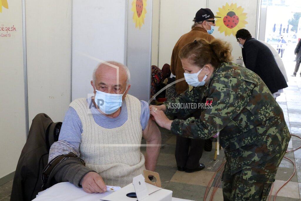 Hektor Pustina A man receives a dose of Sinovac COVID-19 vaccine in Tirana, Albania, Sunday, March 28, 2021. Albania started a mass vaccination campaign trying to inoculate half a million people opening the way to a more relaxed incoming summer tourism season. (AP Photo/Hektor Pustina)
