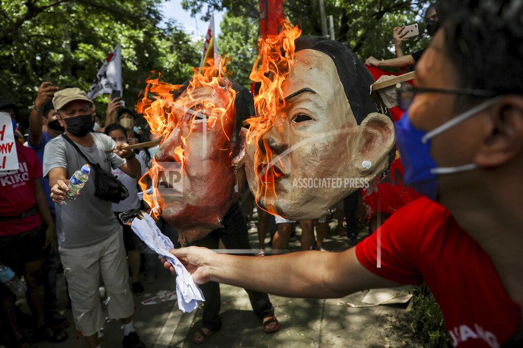Basilio Sepe Activists burn masks of Ferdinand "Bongbong" Marcos Jr. and running mate Sara Duterte, daughter of the current president, during a rally at the Commission on Human Rights in Quezon City, metro Manila, Philippines on Wednesday. May 25, 2022. Marcos Jr. continues to lead in the official canvassing of votes. (AP Photo/Basilio Sepe)