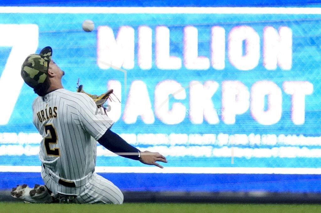 Morry Gash Milwaukee Brewers' Luis Urias makes a running catch on a ball hit by Washington Nationals' Nelson Cruz during the first inning of a baseball game Saturday, May 21, 2022, in Milwaukee. (AP Photo/Morry Gash)