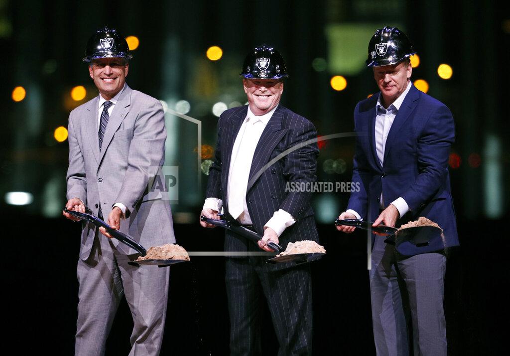 John Locher FILE - In this Nov. 13, 2017, file photo, Raiders owner Mark Davis, center, poses for photographers beside Nevada Gov. Brian Sandoval, left, and NFL commissioner Roger Goodell during a ceremonial groundbreaking for the Raiders' stadium in Las Vegas. Hard to imagine now, but as recently as 15 years ago the NFL rejected Super Bowl advertising from Las Vegas tourism officials. As late as four years ago it forced organizers of a fantasy football convention in the gambling city to cancel their show because Dallas Cowboys quarterback Tony Romo was going to be a featured guest. (AP Photo/John Locher, File)