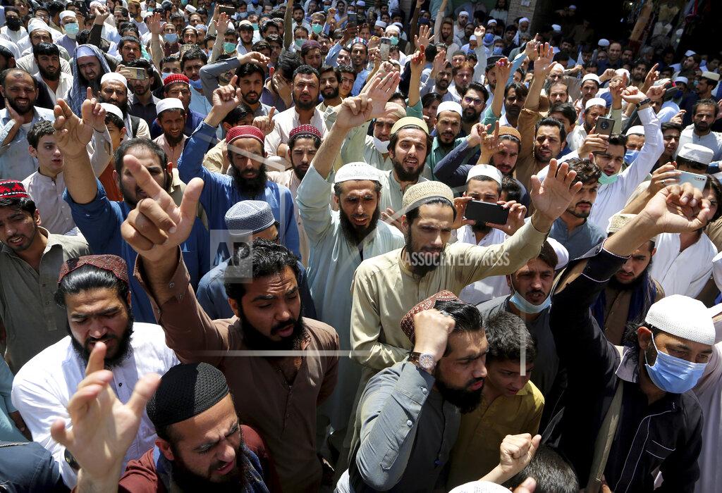 Muhammad Sajjad Traders chant slogans at a rally to condemn the security forces's crackdown against a banned Tehreek-e-Labaik Pakistan party, in Peshawar, Pakistan, Monday, April 19, 2021. An outlawed Pakistani Islamist political group freed 11 policemen almost a day after taking them hostage in the eastern city of Lahore amid violent clashes with security forces, the country's interior minister said Monday. (AP Photo/Muhammad Sajjad)