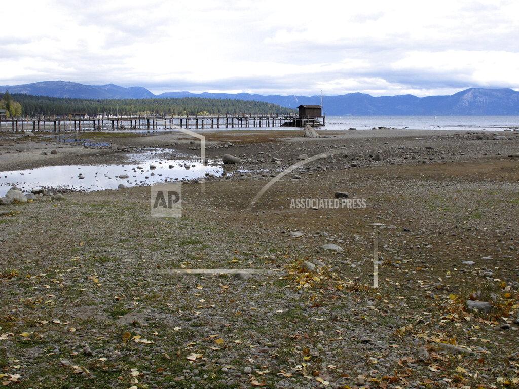 Scott Sonner A pier and dock sits above Lake Tahoe's receding shoreline Wednesday, Oct. 20, 2021 at Tahoe City, Calif. Drought fueled by climate change has dropped Lake Tahoe below its natural rim and halted flows into the Truckee River, an historically cyclical event that's occurring sooner and more often than it used to raising fears about what might be in store for the famed alpine lake. (AP Photo/Scott Sonner).
