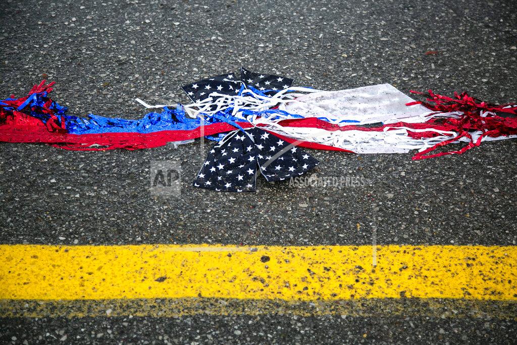 Joseph Cress A piece of a parade float is seen in a puddle as rain pours down after the 4thFest parade was canceled due to severe weather on Independence Day, Monday, July 4, 2022, in Coralville, Iowa. (Joseph Cress/Iowa City Press-Citizen via AP)