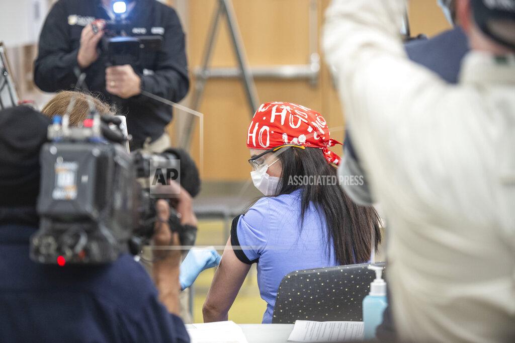 Hector Amezcua Jen Shergill, registered respiratory therapist at UC Davis Medical Center, is prepped before receiving with Pfizer-BioNTech COVID-19 vaccine by nurse Heather Donaldson at UC Davis Medical Center, Tuesday, Dec. 15, 2020 in Sacramento, Calif. (AP Photo/Hector Amezcua, Pool)