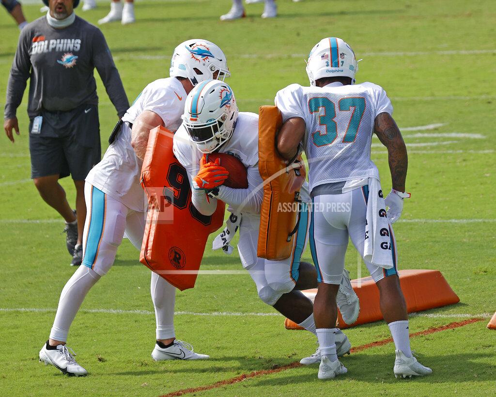 Joel Auerbach Miami Dolphins running back Patrick Laird (32), left, running back Jordan Howard (34), center, and running back Myles Gaskin (37) run a drill during an NFL football training camp practice in Davie, Fla., Monday, Aug. 17, 2020. (AP Photo/Joel Auerbach)