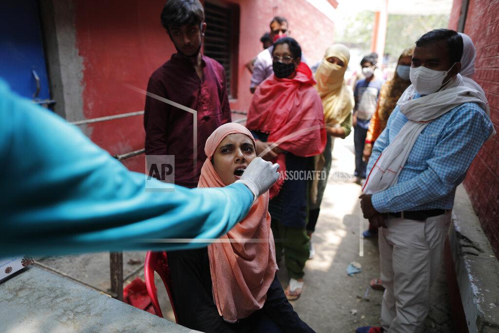 Rajesh Kumar Singh A health worker takes a swab sample to test for COVID-19 in Prayagraj, India, Saturday, April 17, 2021. The global death toll from the coronavirus topped a staggering 3 million people Saturday amid repeated setbacks in the worldwide vaccination campaign and a deepening crisis in places such as Brazil, India and France. (AP Photo/Rajesh Kumar Singh)