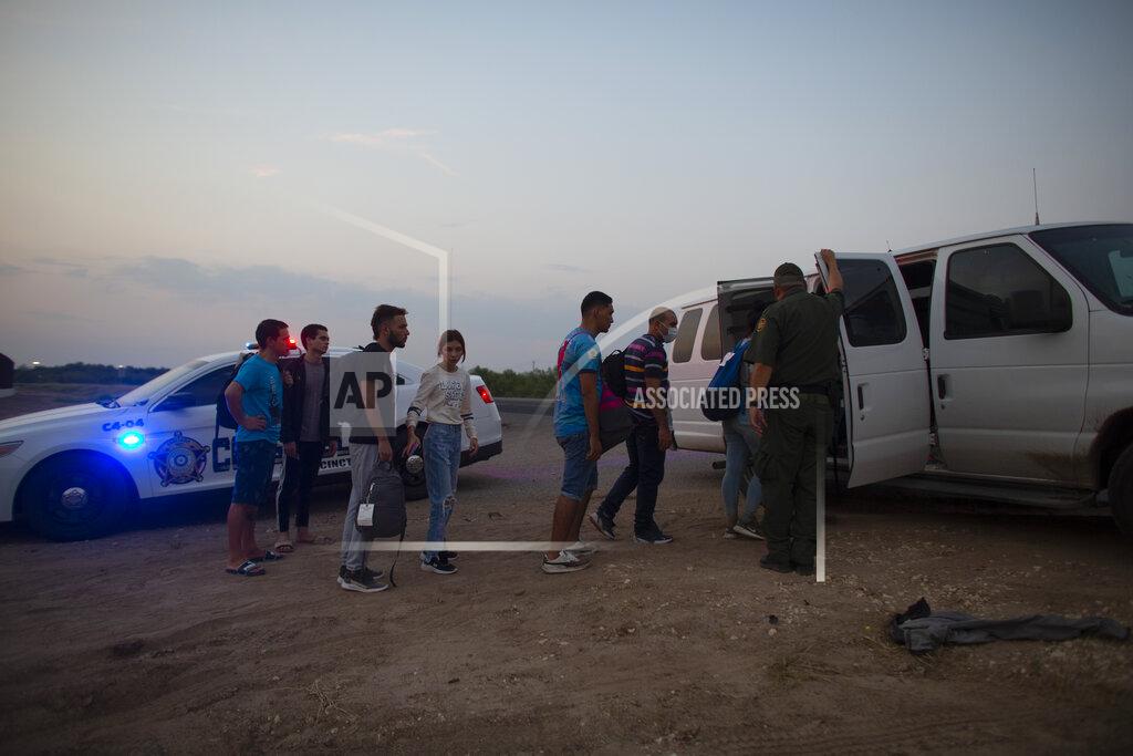 Dario Lopez-Mills Migrants who had crossed the Rio Grande river into the United States are taken away by Border Patrol agents in Eagle Pass, Texas, Saturday, May 21, 2022. The Eagle Pass area has become increasingly a popular crossing corridor for migrants, especially those from outside Mexico and Central America, under Title 42 authority, which expels migrants without a chance to seek asylum on grounds of preventing the spread of COVID-19. (AP Photo/Dario Lopez-Mills)