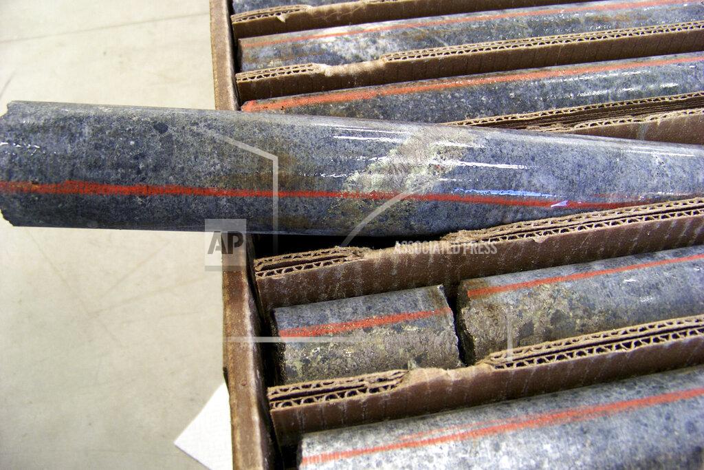 FILE - In this Oct. 4, 2011, file photo, a core sample drilled from underground rock near Ely, Minn., shows a band of shiny minerals containing copper, nickel and precious metals, center, that Twin Metals Minnesota LLC, hopes to mine near the Boundary Waters Canoe Area Wilderness in northeastern Minnesota. Minnesota officials say they will do a state environmental impact statement for a proposed copper-nickel mine upstream of the Boundary Waters Canoe Area. (AP Photo/Steve Karnowski, File)