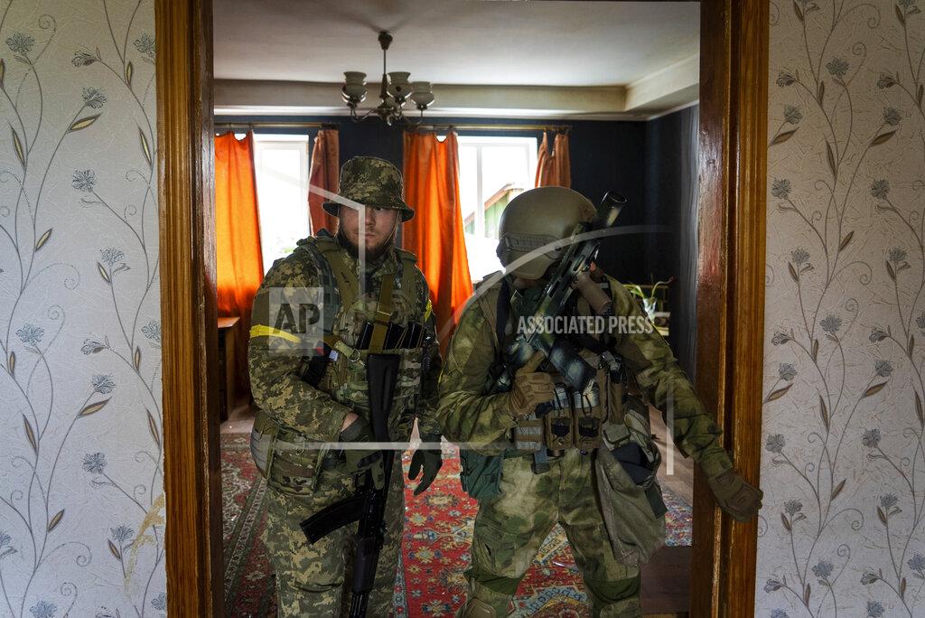 Mstyslav Chernov Ukrainian servicemen inspect a house during a reconnaissance mission in a recently retaken village on the outskirts of Kharkiv, east Ukraine, Saturday, May 14, 2022. (AP Photo/Mstyslav Chernov)