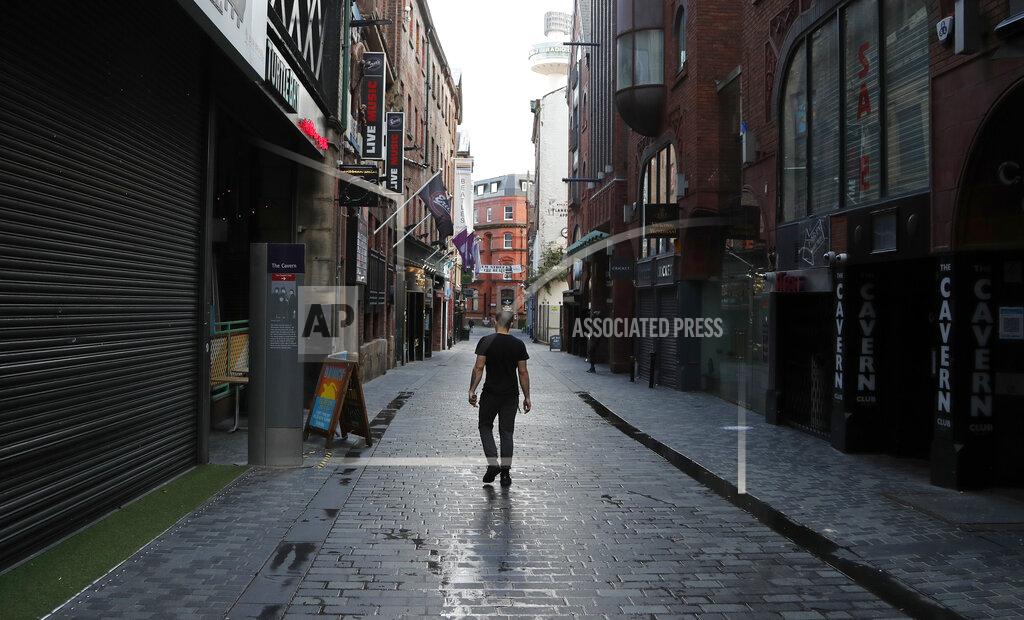 Frank Augstein A lone man walks, past the famous Cavern club and other closed pubs and bars as new anti-coronavirus measures are set to come into force in Liverpool, England, Wednesday, Oct. 14, 2020. (AP Photo/Frank Augstein)