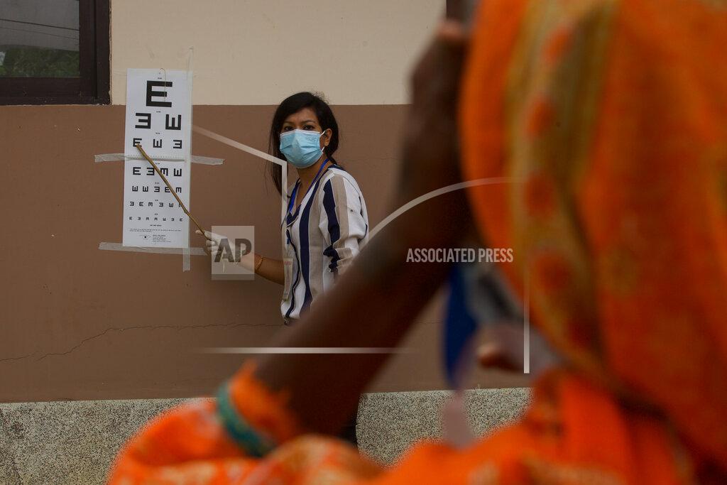 Bikram Rai A patient gets her eye checked during her follow up after her cataract surgery at an eye camp in Lumbini, 288 kilometers (180 miles) south west of Kathmandu, Nepal, March 31, 2021. Nepal’s “God of Sight” eye doctor renowned for his innovative and inexpensive cataract surgery for the poor is taking his work beyond the Himalayan mountains to other parts of the world so there is no more unnecessary blindness in the world. Ruit, who has won many awards for his work and performed some 130,000 cataract surgery in the past three decades, is aiming to expand his work beyond the borders of his home country and the region to go globally. (AP Photo/Bikram Rai)