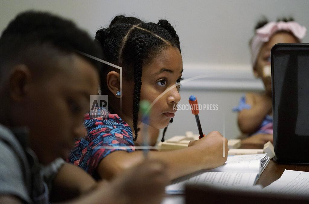 Eric Gay Jacoby Brown, 11, left, and sister, 9, practice math at their home in Austin, Texas, Tuesday, July 13, 2021. The U.S. Census Bureau reported in March that the rate of households homeschooling their children rose to 11% by September 2020, more than doubling from 5.4% just six months earlier. (AP Photo/Eric Gay)