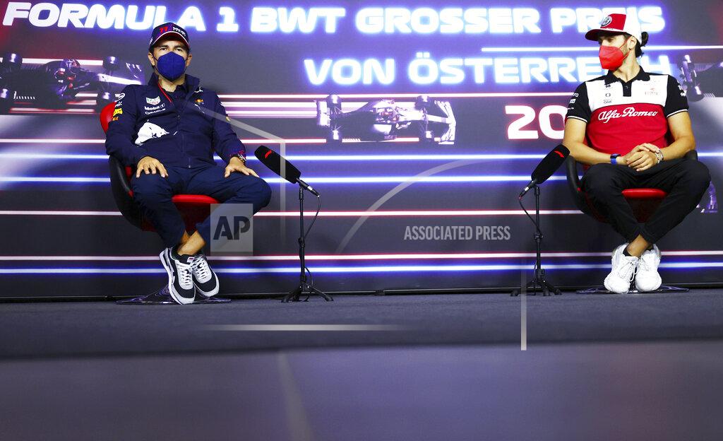 Dan Istitene Red Bull driver Sergio Perez of Mexico, left, and Alfa Romeo driver Antonio Giovinazzi of Italy attend a media conference ahead of the Austrian Formula One Grand Prix at the Red Bull Ring racetrack in Spielberg, Austria, Thursday, July 1, 2021. (Dan Istitene/Pool Photo via AP)
