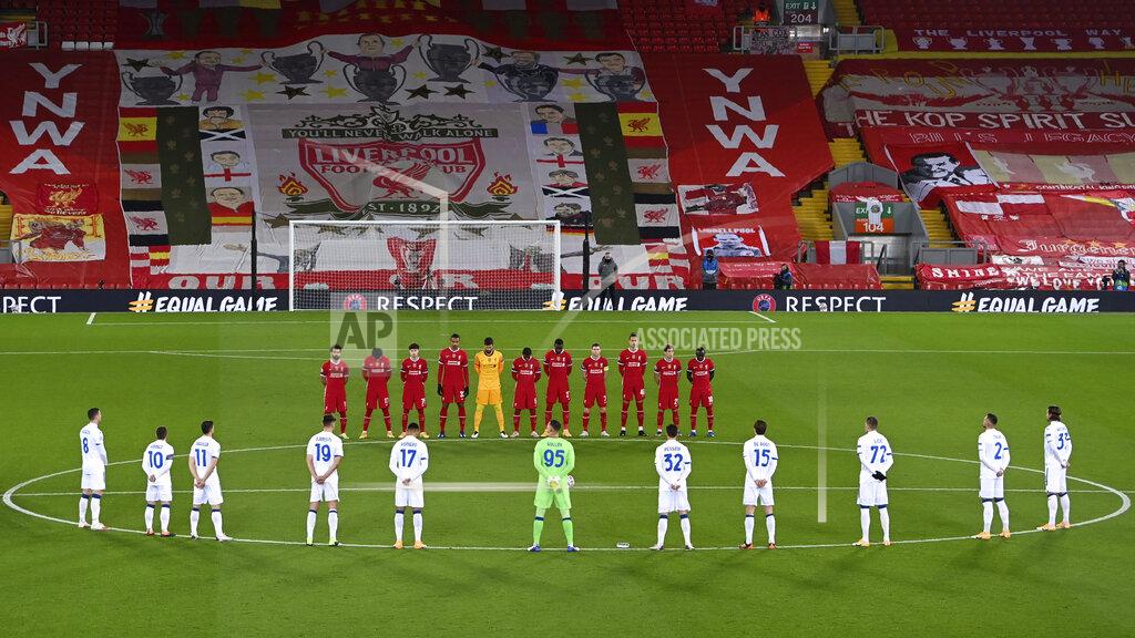 Laurence Griffiths Liverpool, background, and Atalanta players observe a moment of silence in memory of soccer legend Diego Armando Maradona before the start of the Champions League group D soccer match between Liverpool and Atalanta at Anfield stadium in Liverpool, England, Wednesday, Nov. 25, 2020. Maradona died from a heart attack on Wednesday at his home in Buenos Aires. (Laurence Griffiths/Pool via AP)
