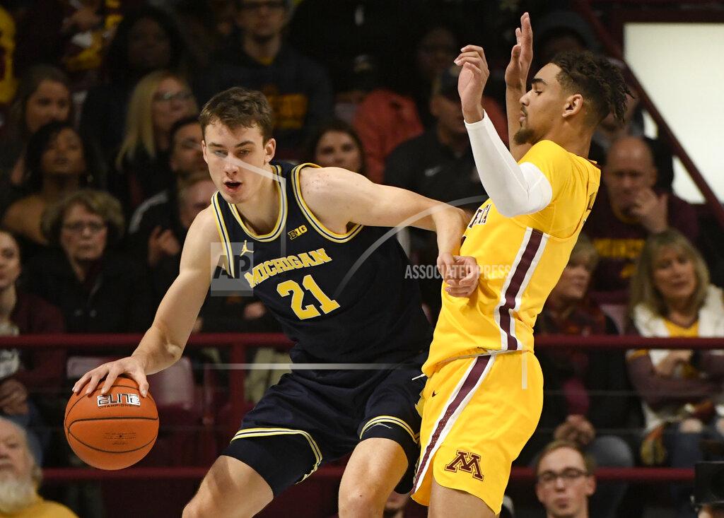 Hannah Foslien Minnesota's Tre' Williams, right, guards against Michigan's Franz Wagner (21) in the first half during an NCAA college basketball game on Sunday, Jan. 12, 2020, in Minneapolis. (AP Photo/Hannah Foslien)