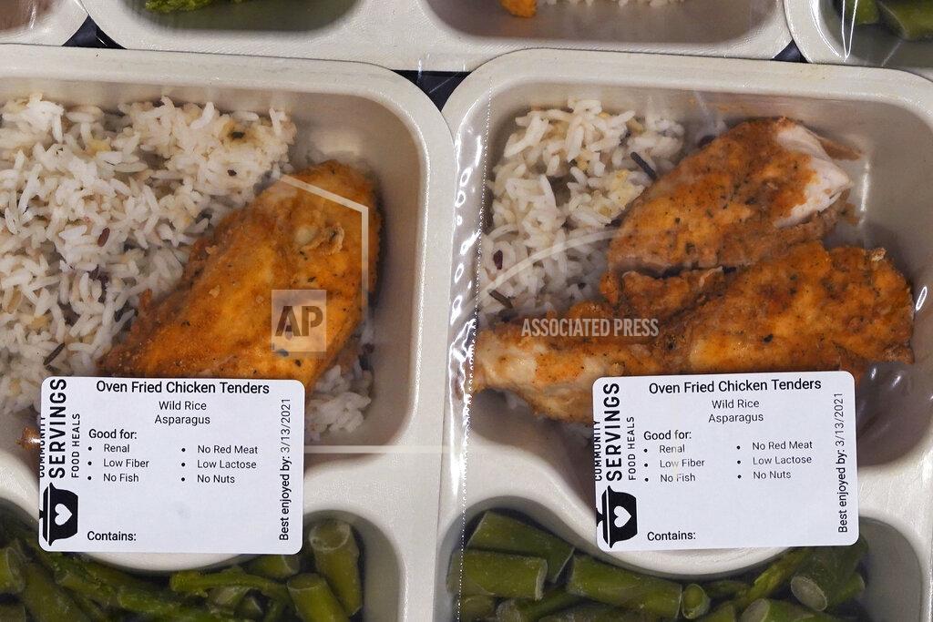 Charles Krupa Freshly made meals, with dietary labels, are packaged for clients at Community Servings, which prepares and delivers scratch-made, medically tailored meals to individuals & families living with critical & chronic illnesses, Tuesday, Jan. 12, 2021, in the Jamaica Plain neighborhood of Boston. Food is a growing focus for insurers as they look to improve the health of the people they cover and cut costs. Insurers first started covering Community Servings meals about five years ago, and CEO David Waters says they now cover close to 40%. (AP Photo/Charles Krupa)