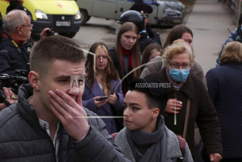 Uncredited Students react as they gather outside the Perm State University in Perm, about 1,100 kilometers (700 miles) east of Moscow, Russia, Monday, Sept. 20, 2021. A gunman opened fire in a university in the Russian city of Perm on Monday morning, leaving at least eight people dead and others wounded, according to Russia's Investigative Committee. (AP Photo)