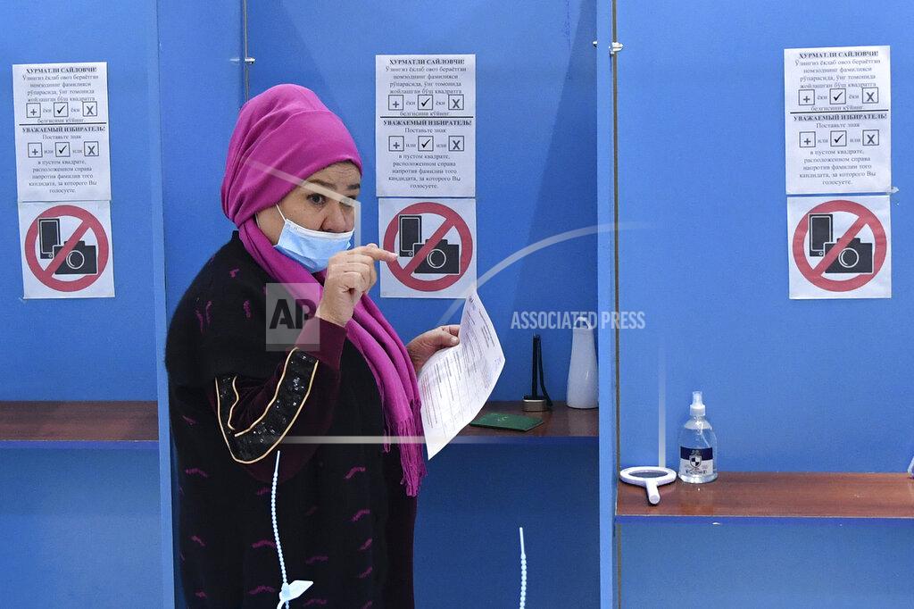 Uncredited A woman walks to cast her ballot at a polling station during the presidential election in Tashkent, Uzbekistan, Sunday, Oct. 24, 2021. Uzbekistan's President, Shavkat Mirziyoyev, who has relaxed many of the policies of his dictatorial predecessor but has made little effort at political reform, is expected to win a new term by a landslide against weak competition in an election Sunday. (AP Photo)