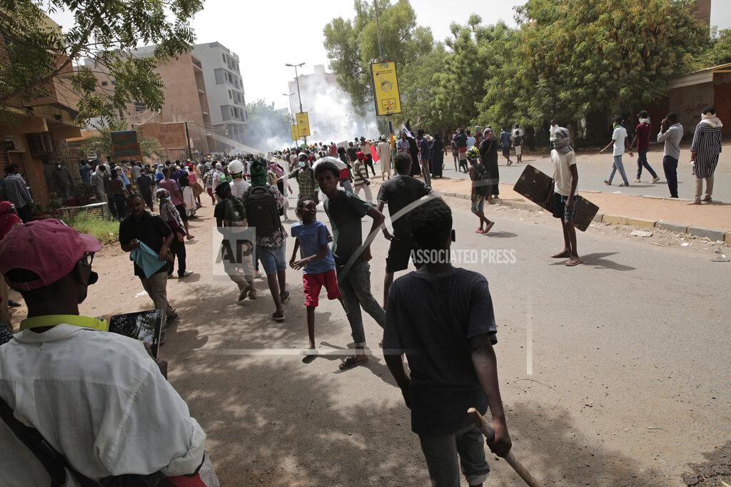 Marwan Ali Protesters clash with security forces as they fire teargas to prevent them from marching towards the presidential palace during demonstrations demanding civilian rule, in Khartoum, Sudan, Thursday, May 19, 2022. (AP Photo/Marwan Ali)
