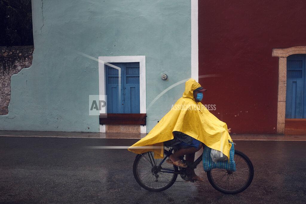 Andres Kudacki A man cycles along an empty street after the passing of Hurricane Delta in Valladolid, Mexico, Wednesday, Oct. 7, 2020. Hurricane Delta made landfall Wednesday just south of the Mexican resort of Cancun as a Category 2 storm, downing trees and knocking out power along the northeastern coast of the Yucatan Peninsula. (AP Photo/Andres Kudacki)