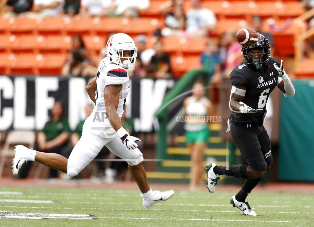 Marco Garcia Hawaii wide receiver Cedric Byrd II (6) pulls in a pass next to Arizona safety Christian Young (5) during the first quarter of an NCAA college football game Saturday, Aug. 24, 2019, in Honolulu. (AP Photo/Marco Garcia)