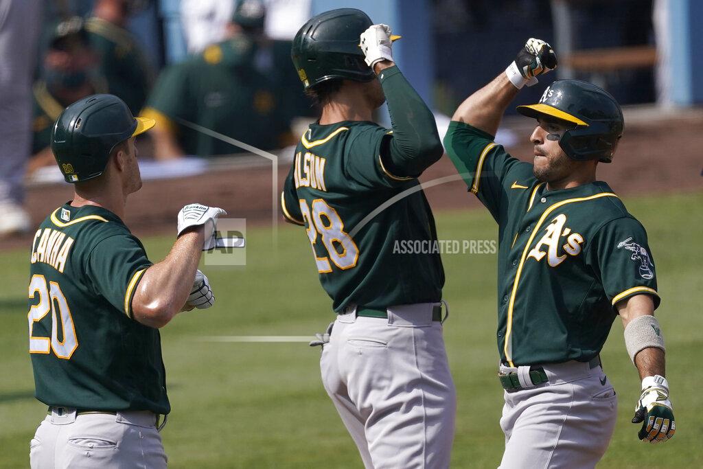 Ashley Landis Oakland Athletics' Ramon Laureano, right, celebrates after hitting a three-run home run that scored Mark Canha (20) and Matt Olson (28) during the second inning of Game 4 of a baseball American League Division Series against the Houston Astros in Los Angeles, Thursday, Oct. 8, 2020. (AP Photo/Ashley Landis)