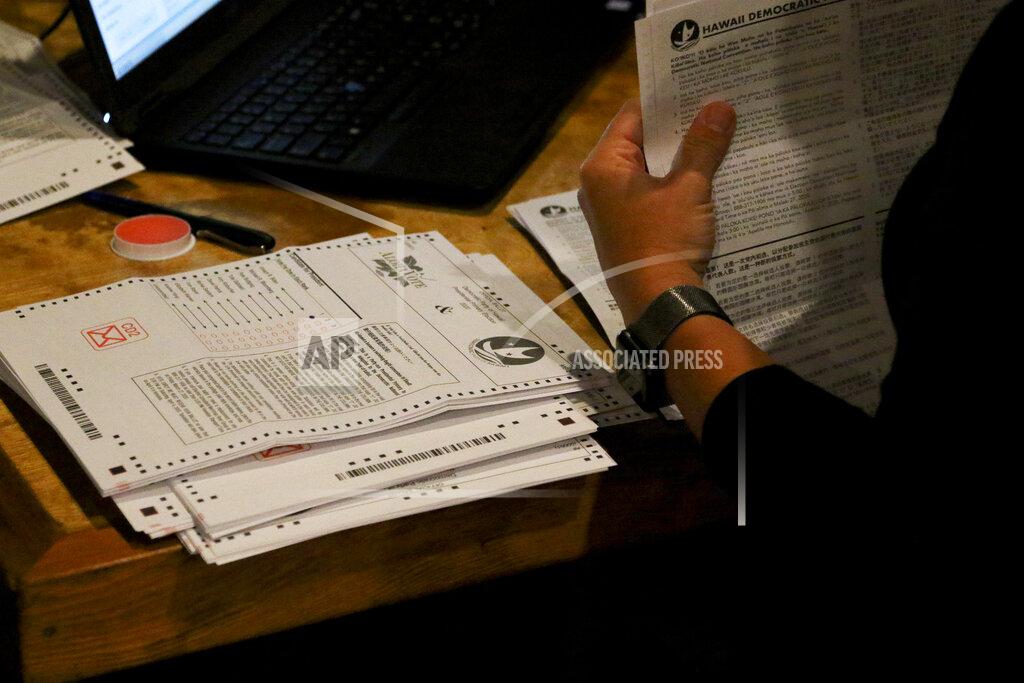 Caleb Jones Democratic Party of Hawaii staff tabulate presidential primary ballots in Honolulu on Friday, May 22, 2020. The Democratic Party of Hawaii is scheduled Saturday to release the results of its party-run presidential primary which was delayed by more than a month due the coronavirus pandemic. The party expected most members to vote by mail and some to cast ballots at about 20 in-person polling sites. But concerns about the virus forced the party to cancel in-person voting and allow only mail ballots. (AP Photo/Caleb Jones)
